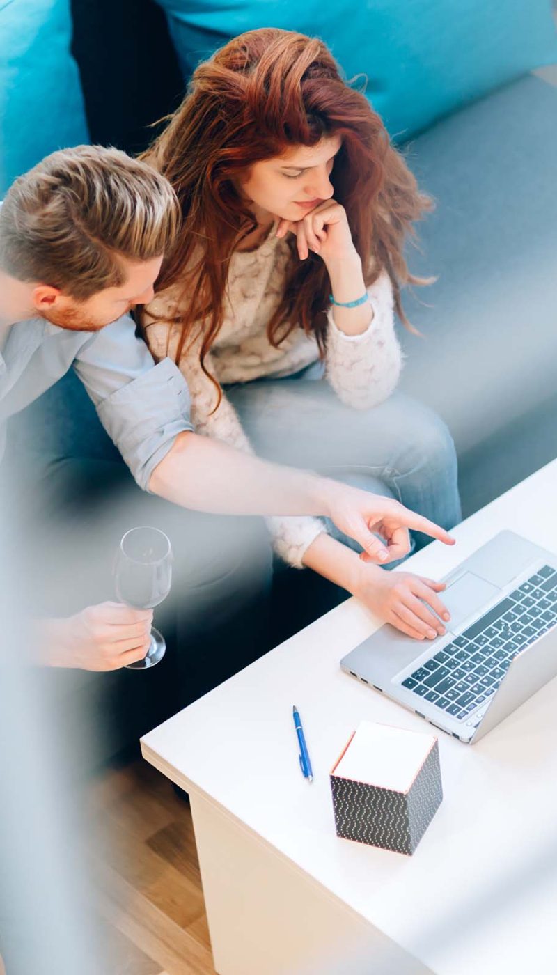 couple-browsing-web-together-in-living-room-JJ5PQHN.jpg